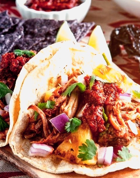 Tacos al pastor with pineapple and salsa roja